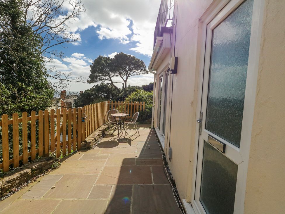 An outdoor area with a table and chairs at Flat B in Bournemouth