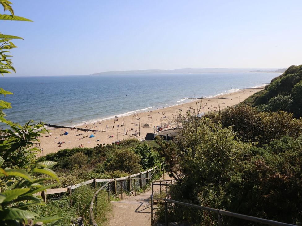 A beach view with people on the sand at Flat B in Bournemouth