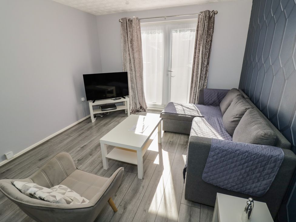 A living room with a sofa and television at 32A Cramp Hill- 1 bed in Darlaston