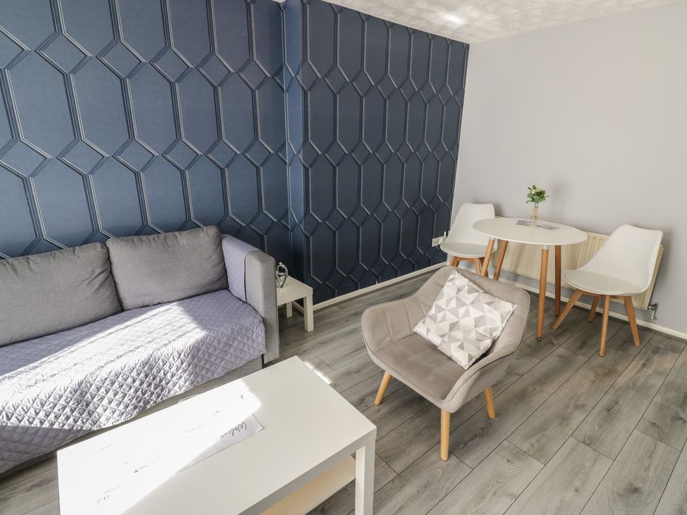 A living room with a sofa and table at 32A Cramp Hill- 1 bed Darlaston