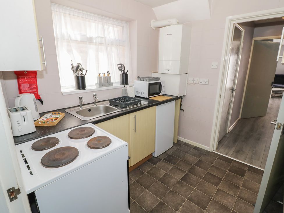A kitchen with a sink and stove at 32A Cramp Hill- 1 bed Darlaston