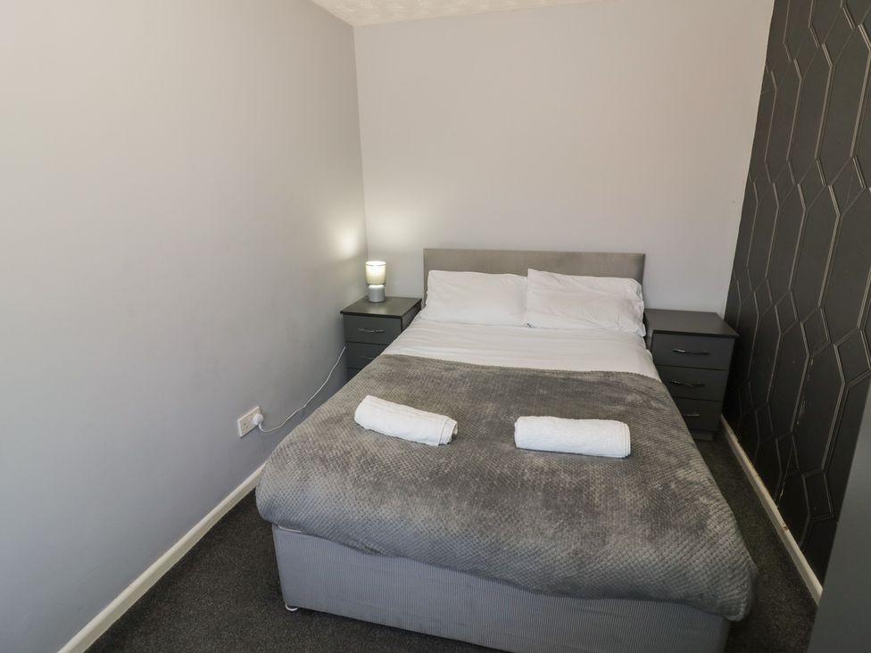 A bedroom with a bed and bedside table at 32A Cramp Hill- 1 bed Darlaston