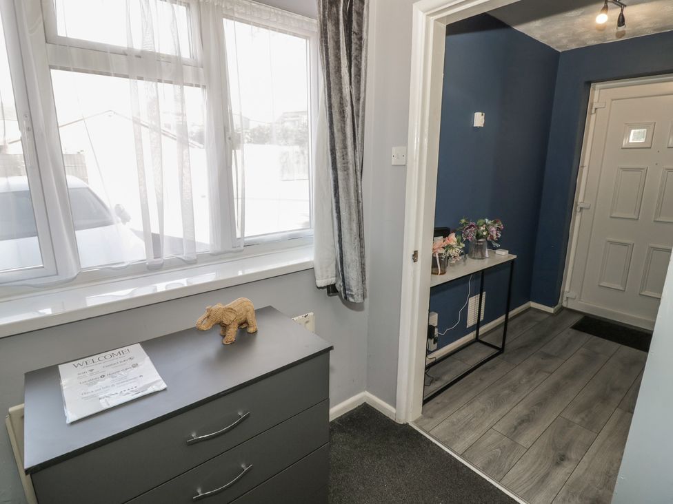 A hallway with a table and decorative items at 32A Cramp Hill- 1 bed in Darlaston