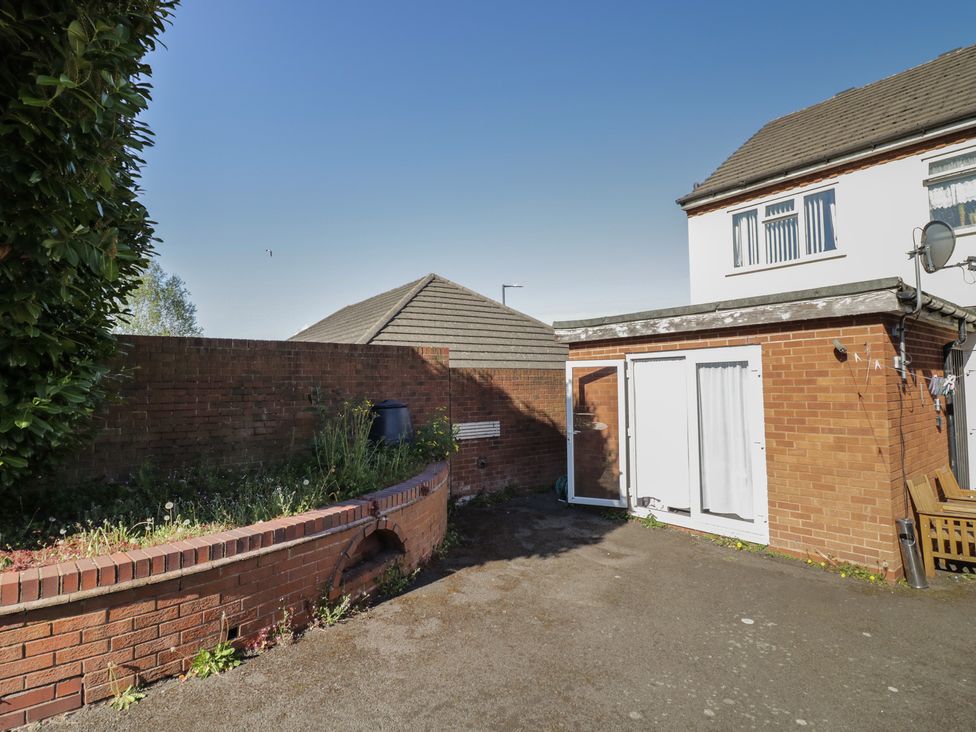 An outdoor area with a building and a flower bed at 32A Cramp Hill- 1 bed Darlaston