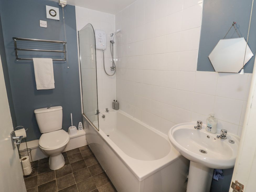 A bathroom with a bathtub, sink, and toilet at 32A Cramp Hill Darlaston
