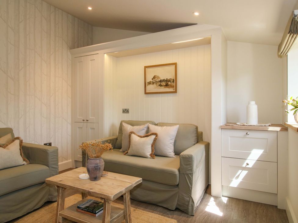 A living room with a sofa and coffee table at Thyme Away in Bucknell