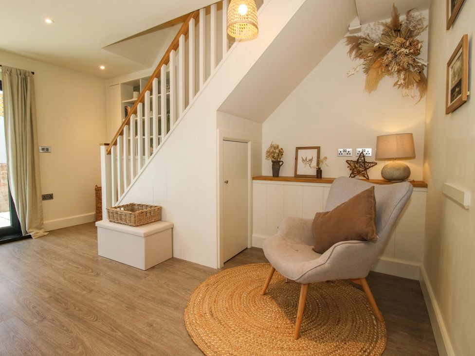 An entryway with a chair and staircase at Thyme Away in Bucknell