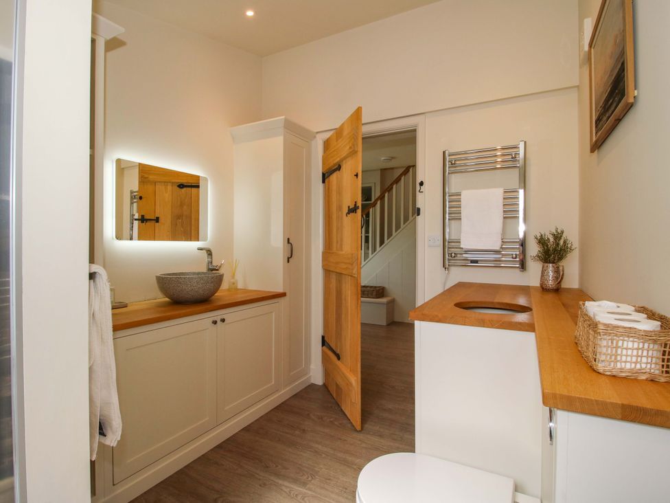 A bathroom with a sink, vanity, and toilet at Thyme Away in Bucknell