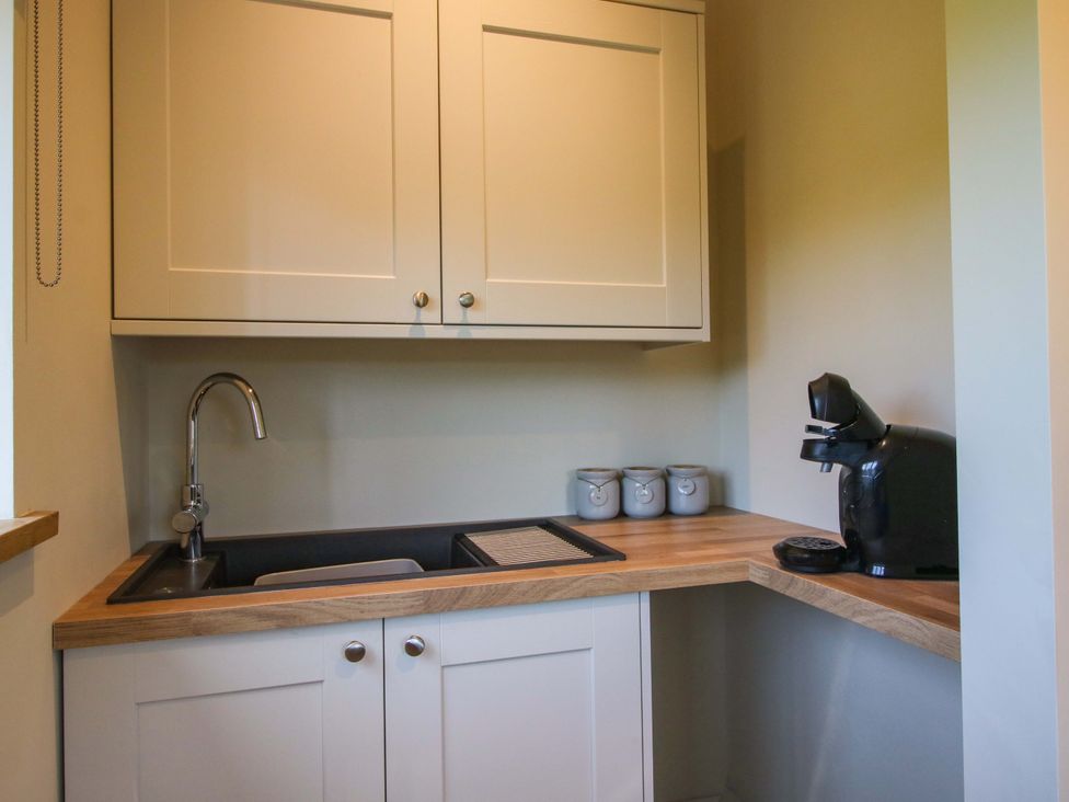 A kitchen with a sink and coffee machine at Thyme Away in Bucknell
