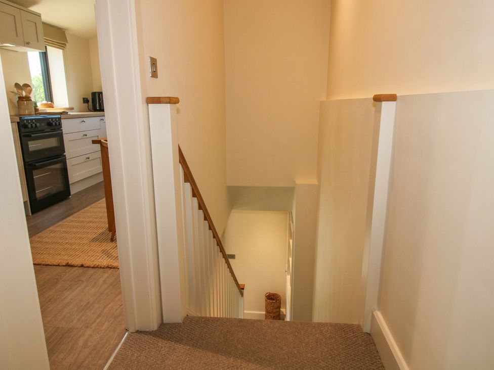 A staircase leading to a kitchen area at Thyme Away in Bucknell
