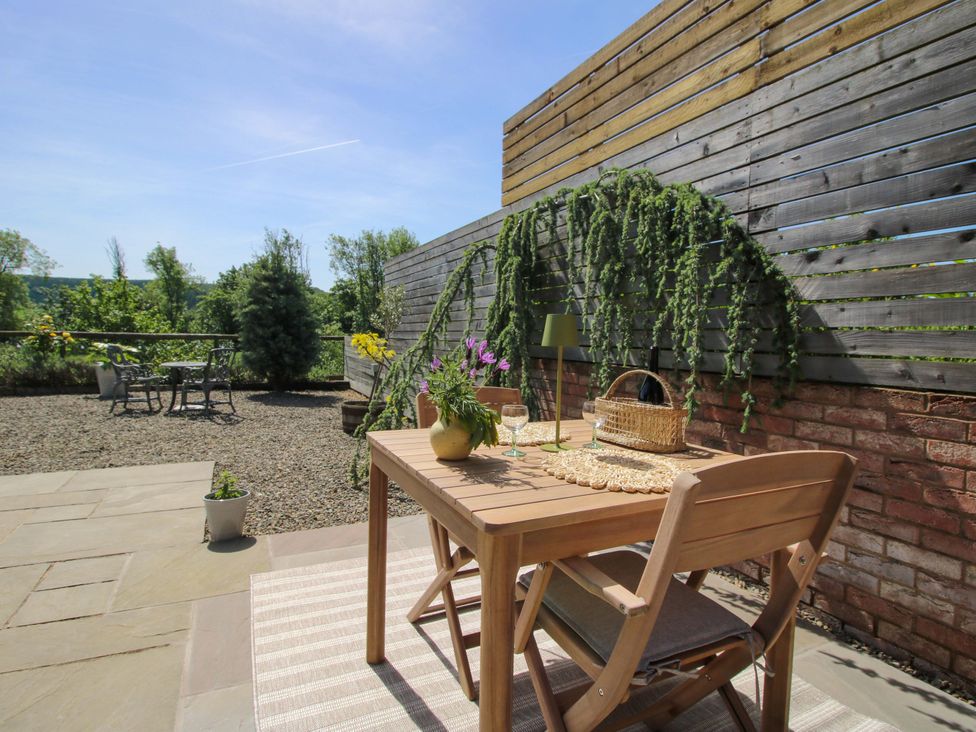 An outdoor area with a table and chairs at Thyme Away in Bucknell