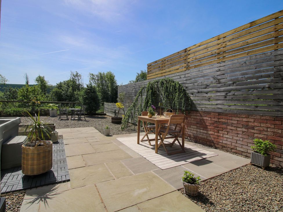 An outdoor seating area with a table and chairs at Thyme Away Bucknell