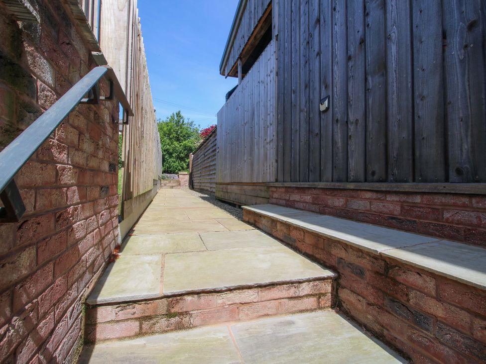 A pathway between wooden fences at Thyme Away in Bucknell