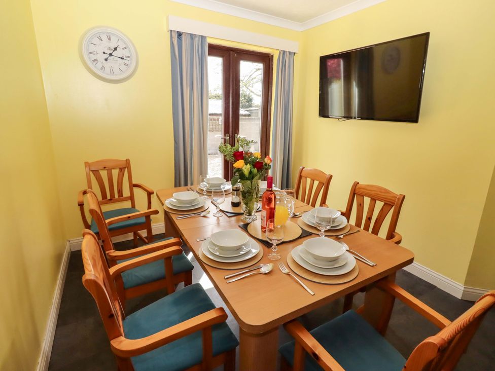 A dining room with a table set for dining at Willow cottage in Seahouses