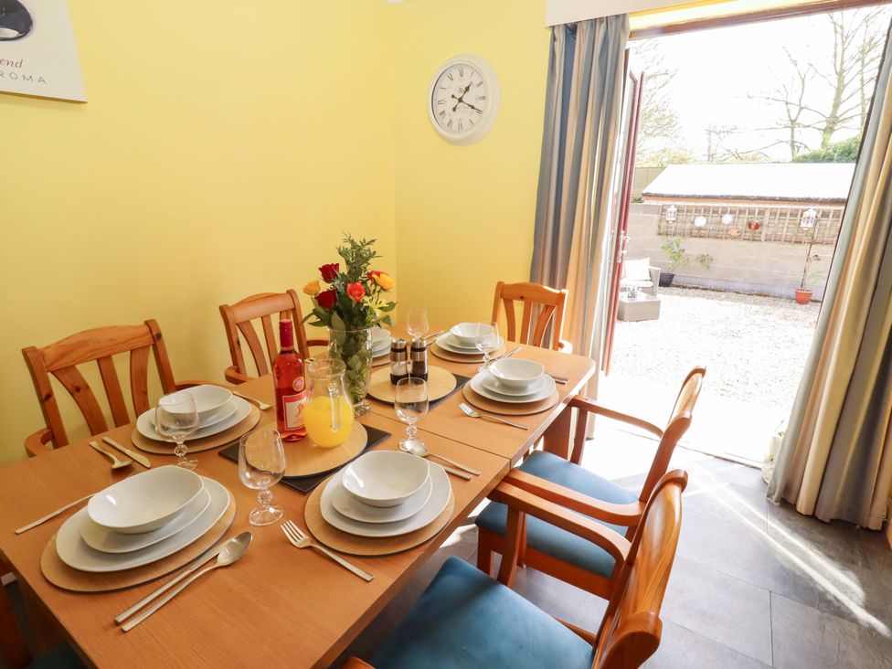A dining room with a table set for a meal at Willow cottage Seahouses
