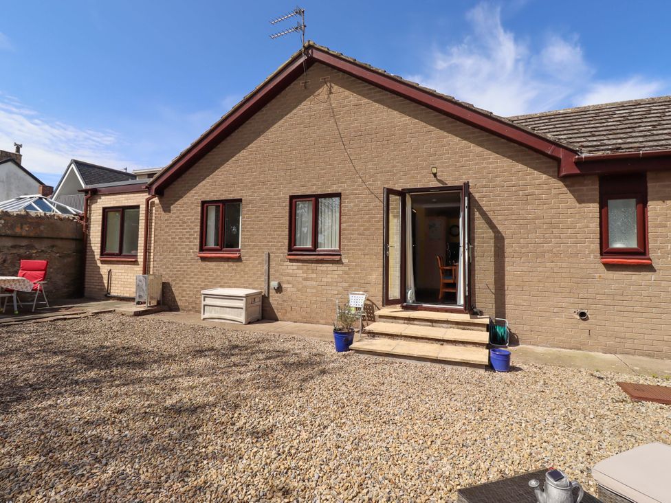 A house exterior with a door and windows at Willow cottage in Seahouses