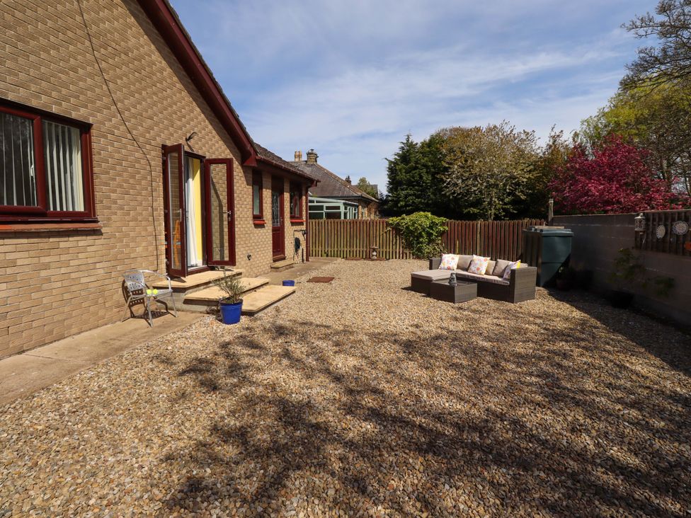 An outdoor space with gravel and seating at Willow cottage Seahouses