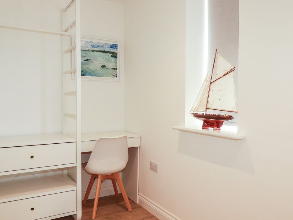 An office with a desk and model ship at Cwtch Treth in Newquay