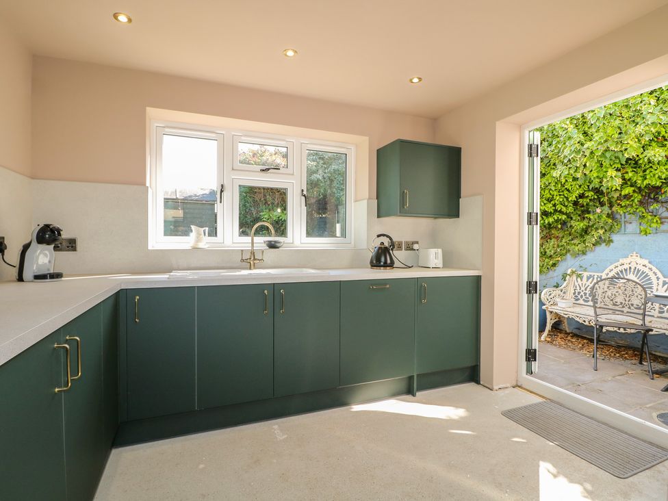 A kitchen with a sink and kettle at Smugglers Cottage in Selsey