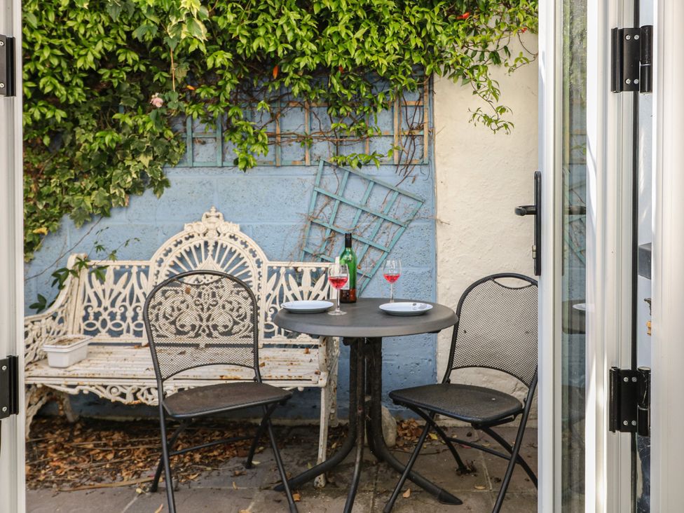 An outdoor seating area with a table and chairs at Smugglers Cottage Selsey