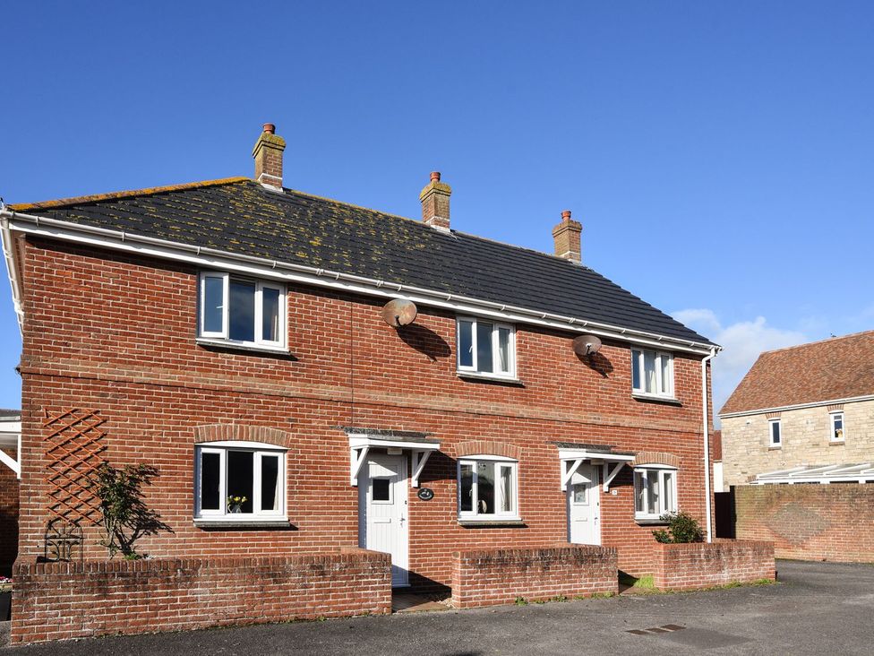 A house with windows and a door at Mead Cottage in Bridport
