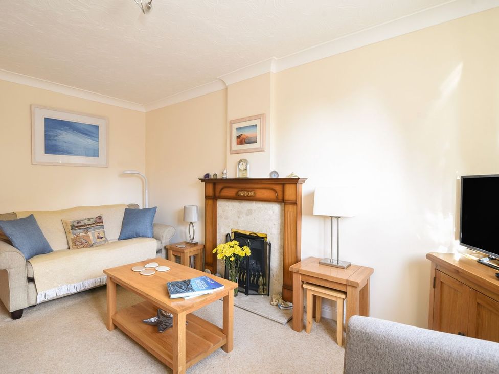A living room with a sofa and coffee table at Mead Cottage in Bridport