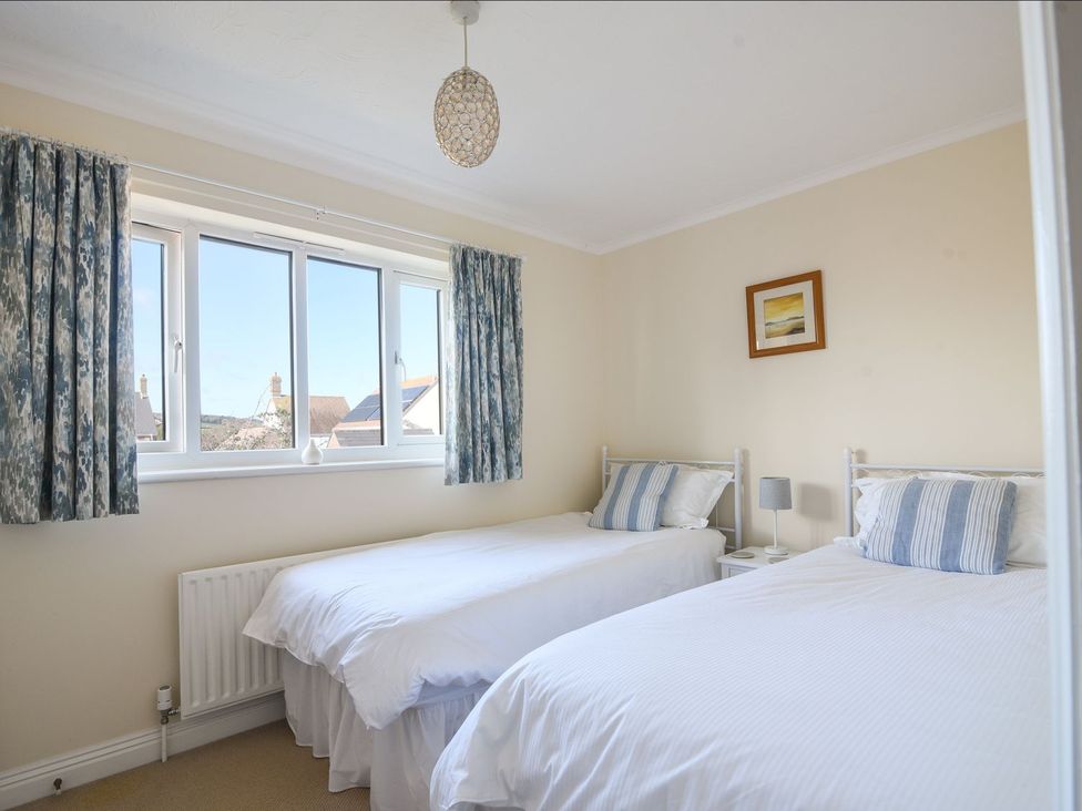 A bedroom with two single beds at Mead Cottage in Bridport