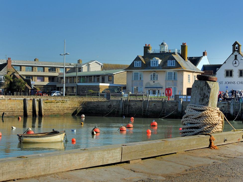 A harbor with boats and buildings at Mead Cottage in Bridport