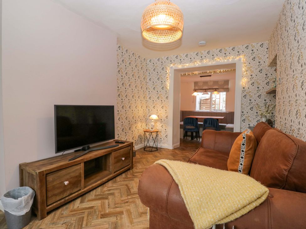 A living room with a sofa and television at The Old Post Office in Whitehaven