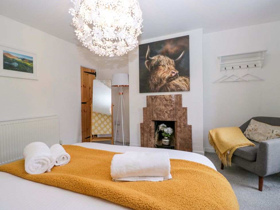 A bedroom with a bed and towels at The Old Post Office in Whitehaven