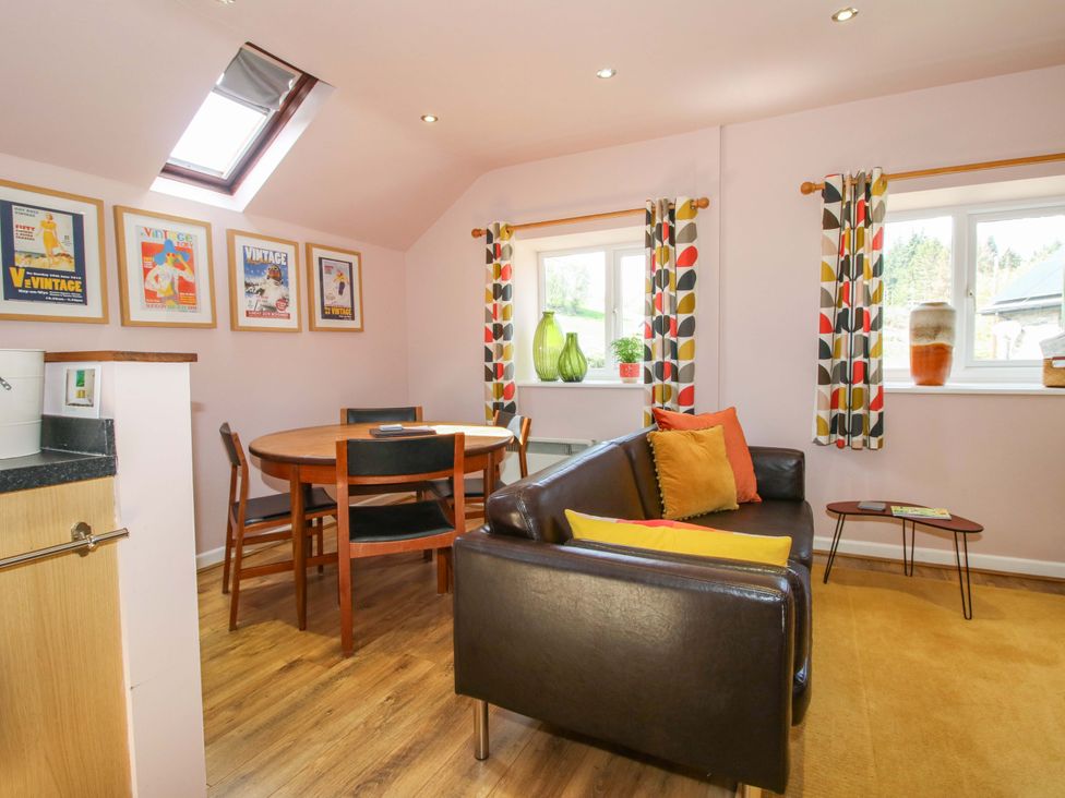 A living room with a circular table and chairs at Pentwyn Barn in Clyro