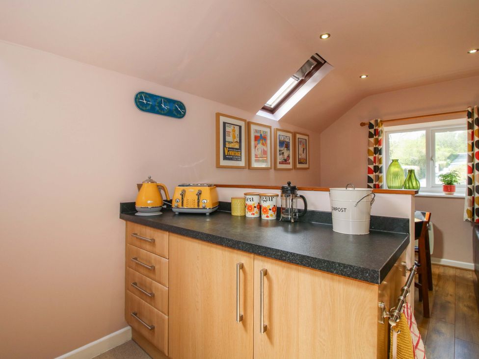 A kitchen with appliances and canisters at Pentwyn Barn in Clyro