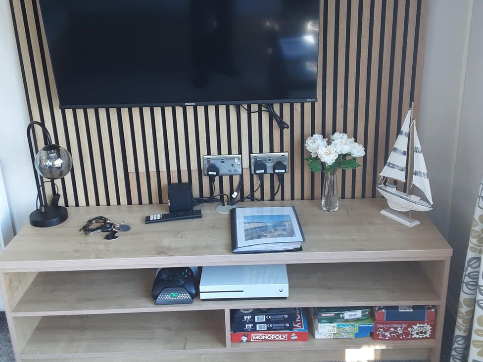 A living room with a television and game console at Josephine MB37 Newquay