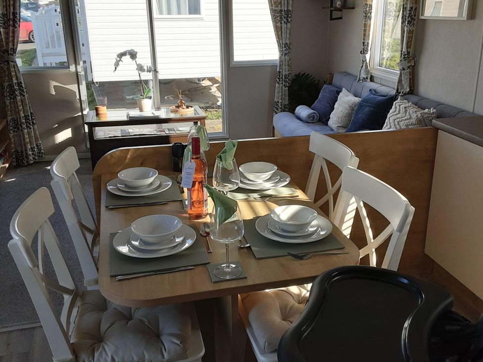 A dining area with a table set for four at Josephine MB37 in Newquay