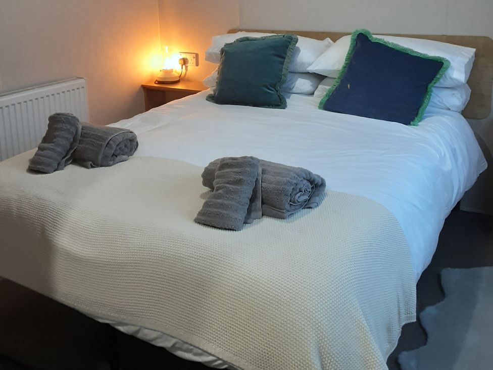 A bedroom with a bed and pillows at Josephine MB37 in Newquay