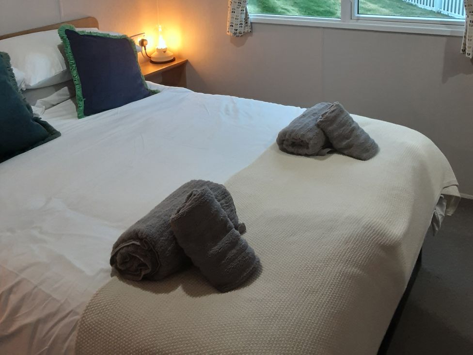 A bedroom with a bed and pillows at Josephine MB37 in Newquay