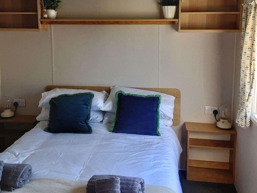 A bedroom with a bed and shelf at Josephine MB37 in Newquay