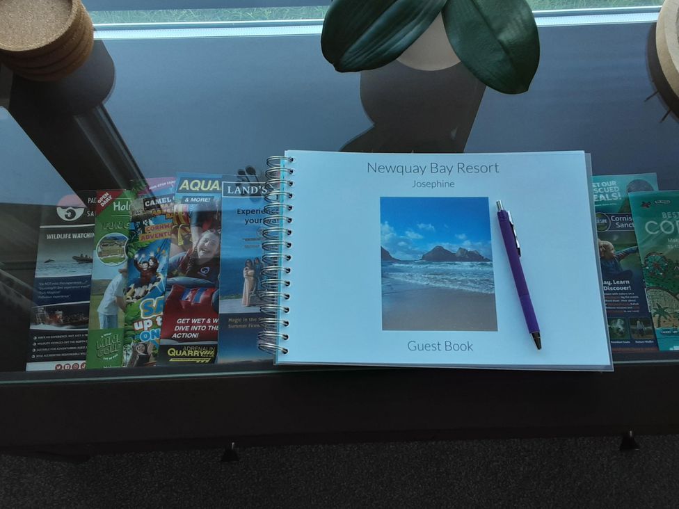 A guest book and brochures on a table at Josephine MB37 Newquay