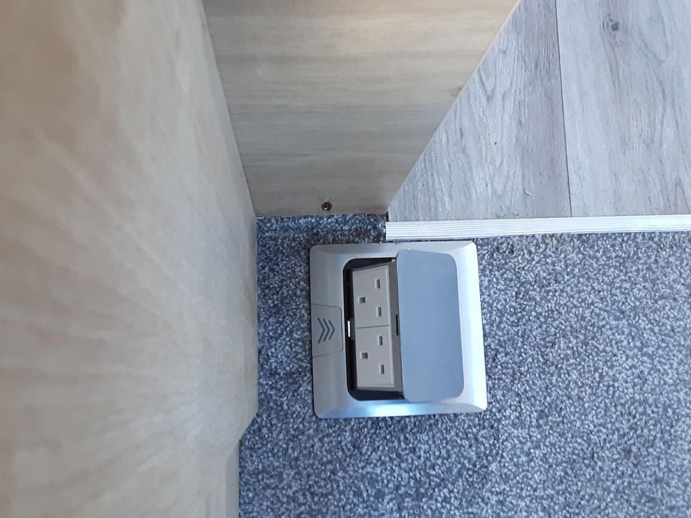 A power outlet on the floor near a wall at Josephine MB37 in Newquay
