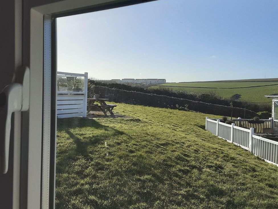A garden with grass and seating area at Josephine MB37 in Newquay