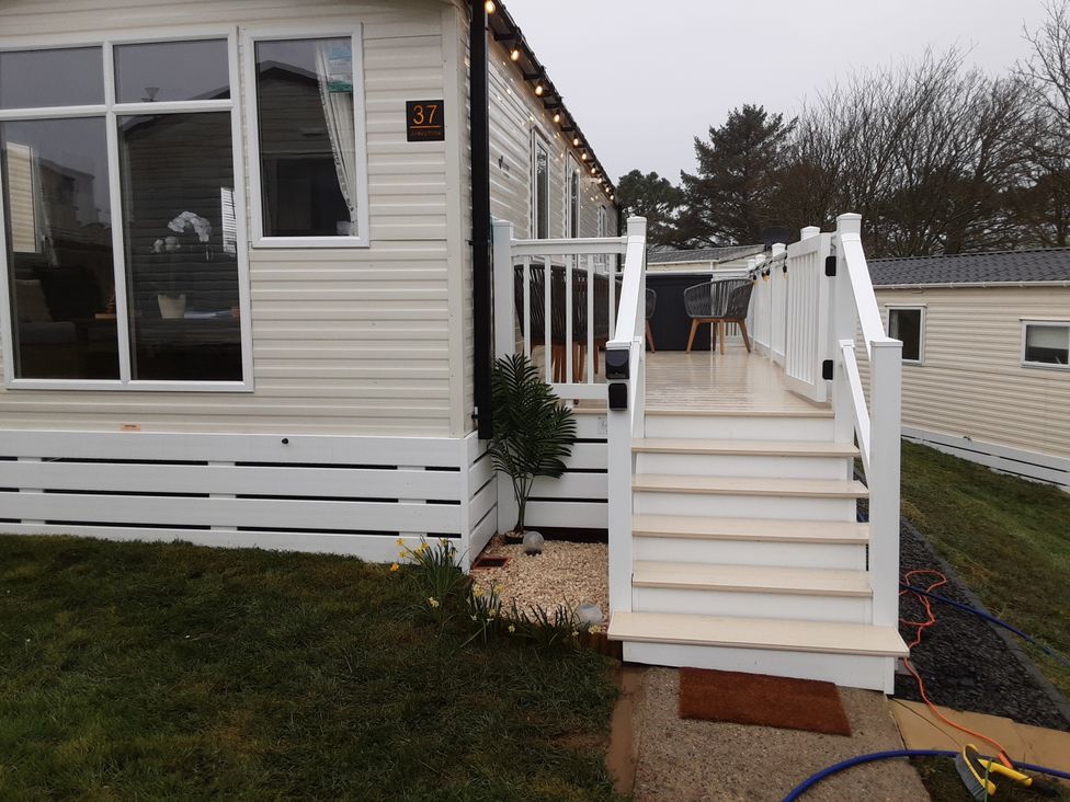An exterior view of a house with stairs and a deck at Josephine MB37, Newquay