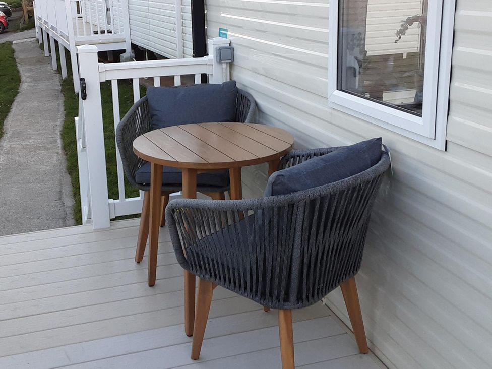 A table and chairs on a patio at Josephine MB37 Newquay