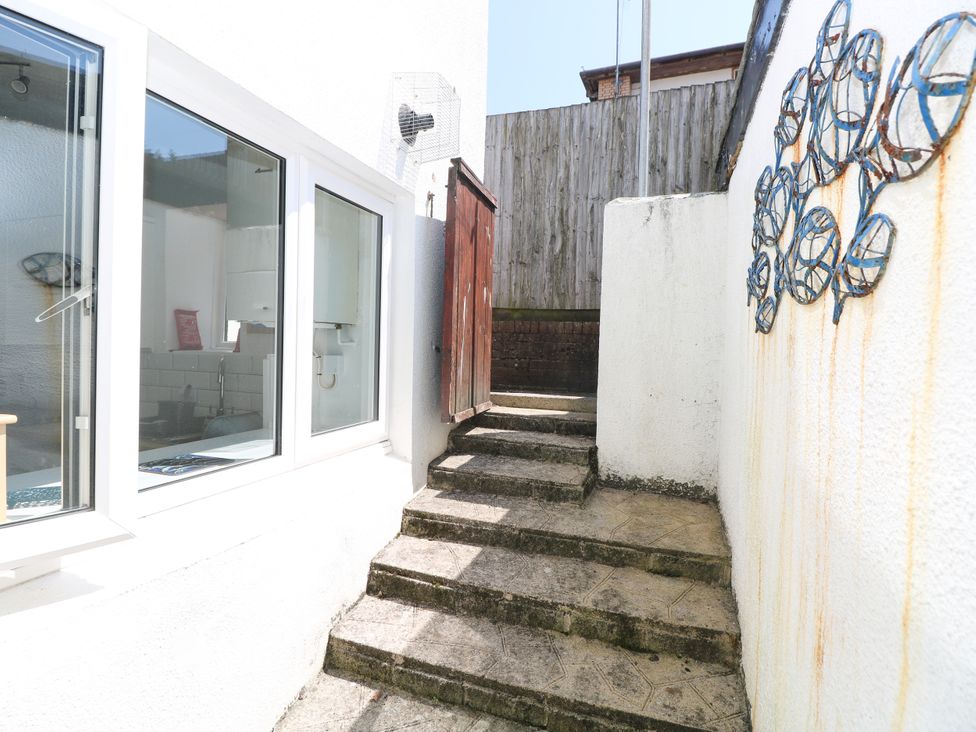 An outdoor area with stairs leading to a wooden shed at 3 Edward Street Tenby