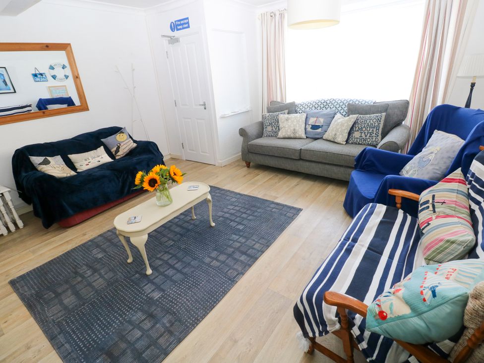 A living room with a sofa and a coffee table at 3 Edward Street in Tenby
