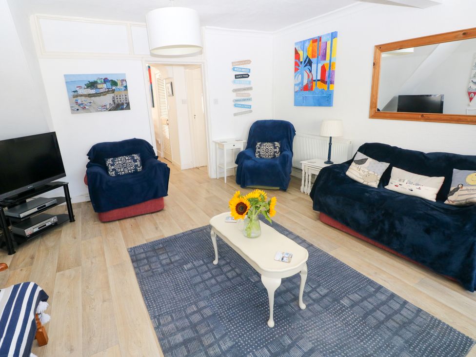 A living room with blue sofas and a coffee table at 3 Edward Street, Tenby