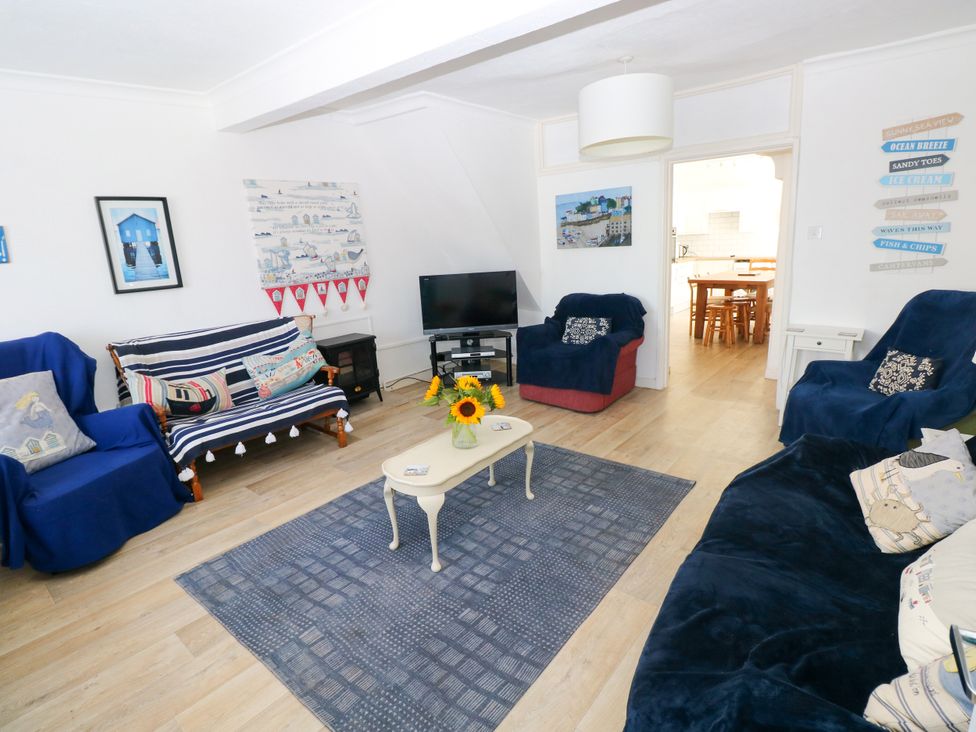 A living room with a television and seating area at 3 Edward Street in Tenby
