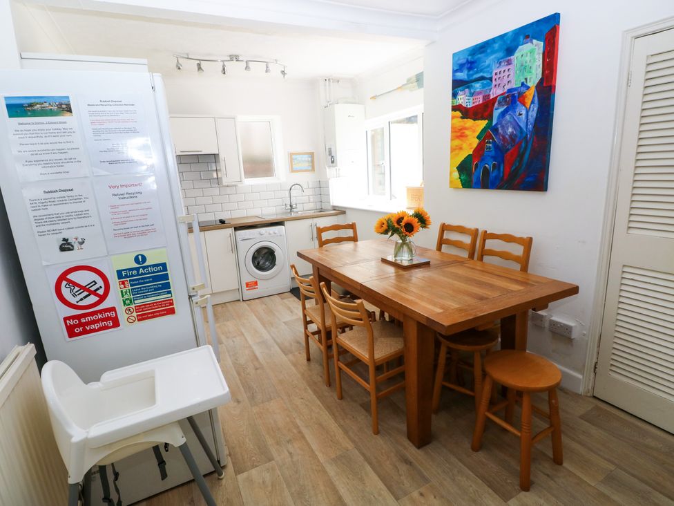 A dining room with a wooden table and chairs at 3 Edward Street Tenby