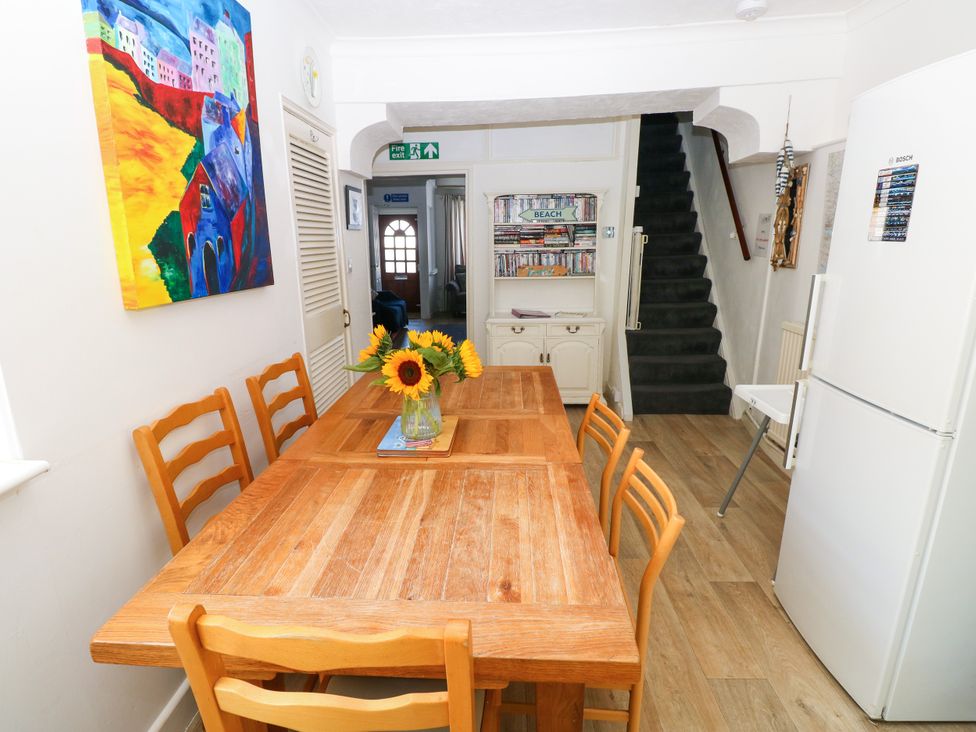 A dining room with a table and chairs at 3 Edward Street Tenby