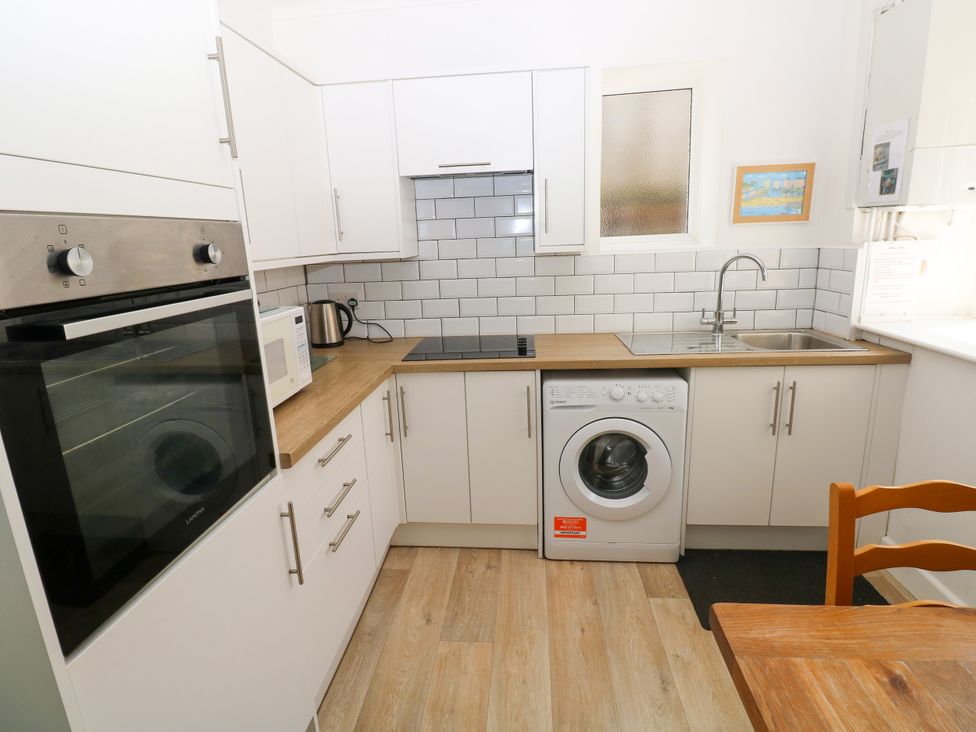 A kitchen with appliances and storage at 3 Edward Street Tenby