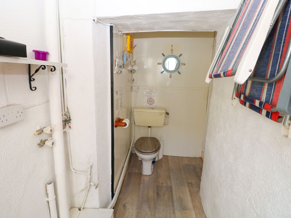 A bathroom with a toilet and shower at 3 Edward Street Tenby